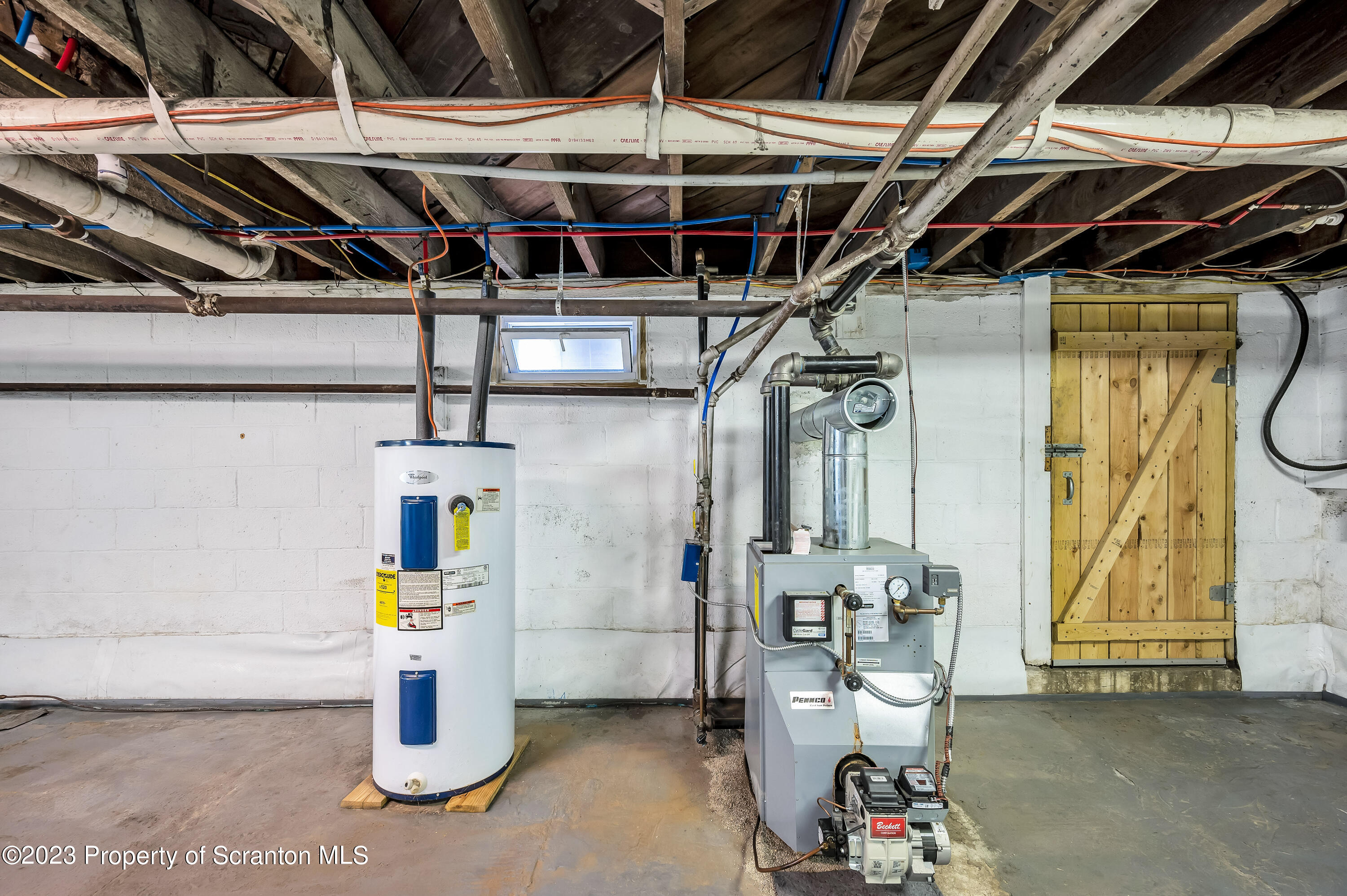 709 Meade Street Throop, PA 18512 - Photo 30 of 37 a view of storage and utility room with racks on the wall