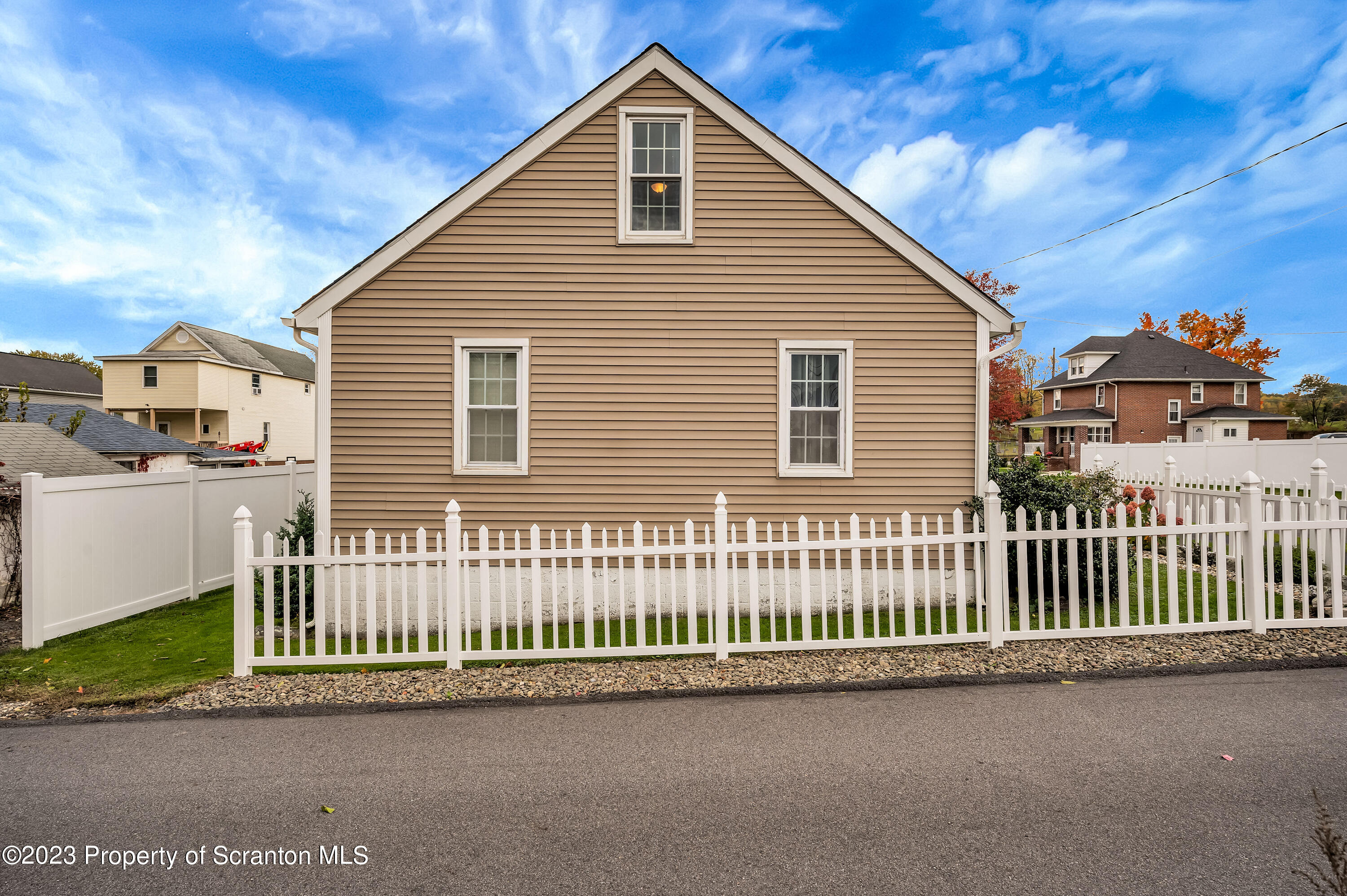709 Meade Street Throop, PA 18512 - Photo 37 of 37 a view of a house with a small yard and wooden fence