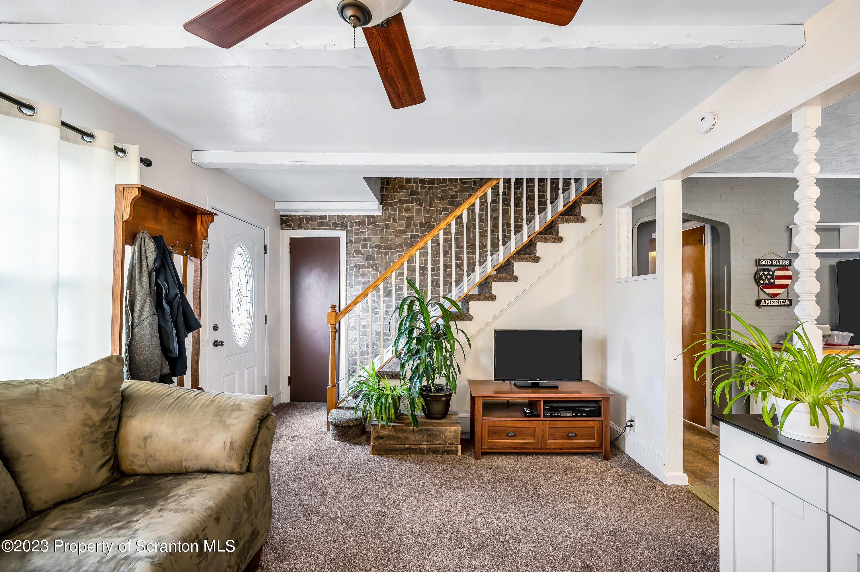 709 Meade Street Throop, PA 18512 - Photo 7 of 37 a living room with furniture and a flat screen tv