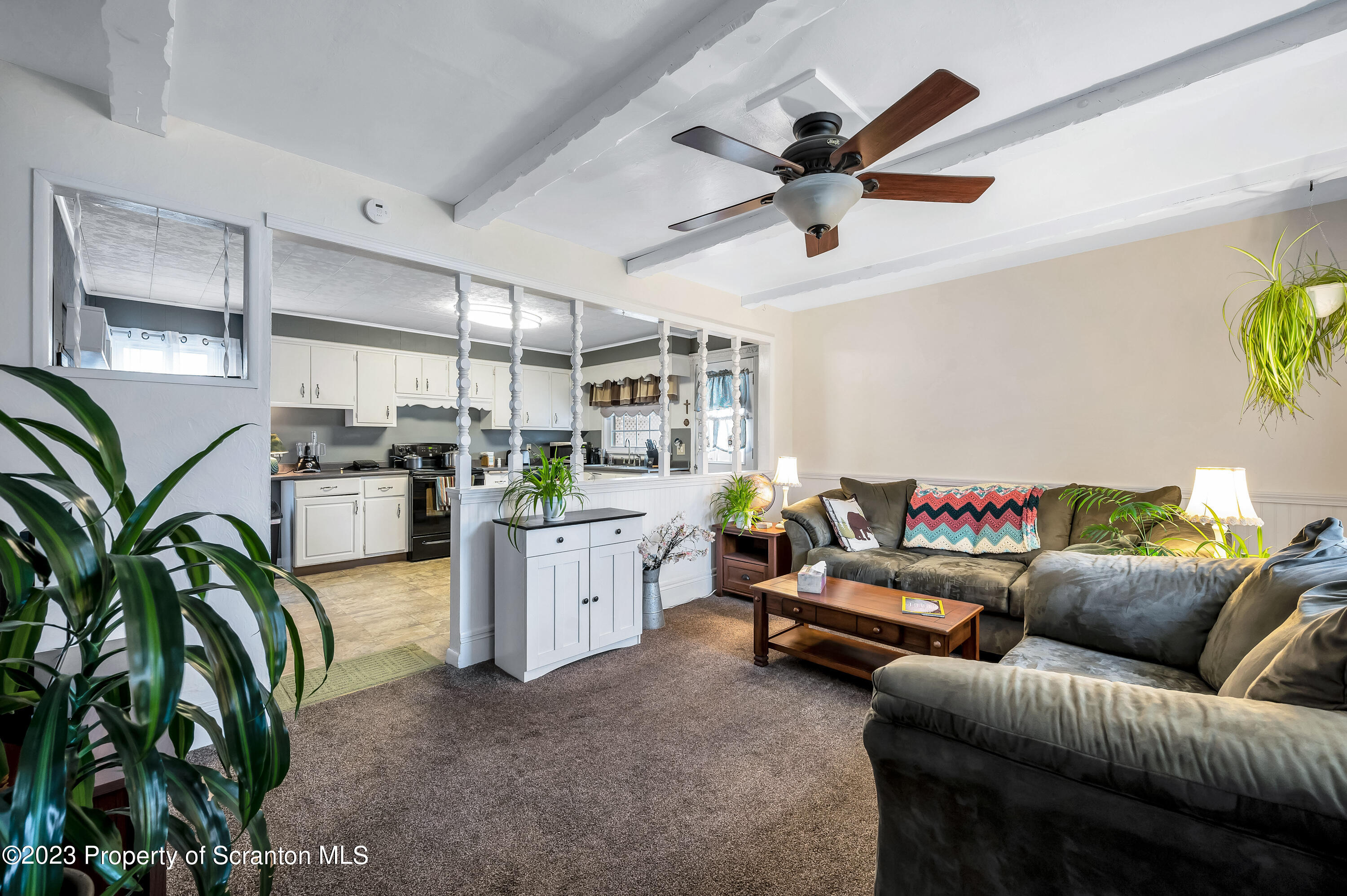 709 Meade Street Throop, PA 18512 - Photo 8 of 37 a living room with furniture and kitchen view