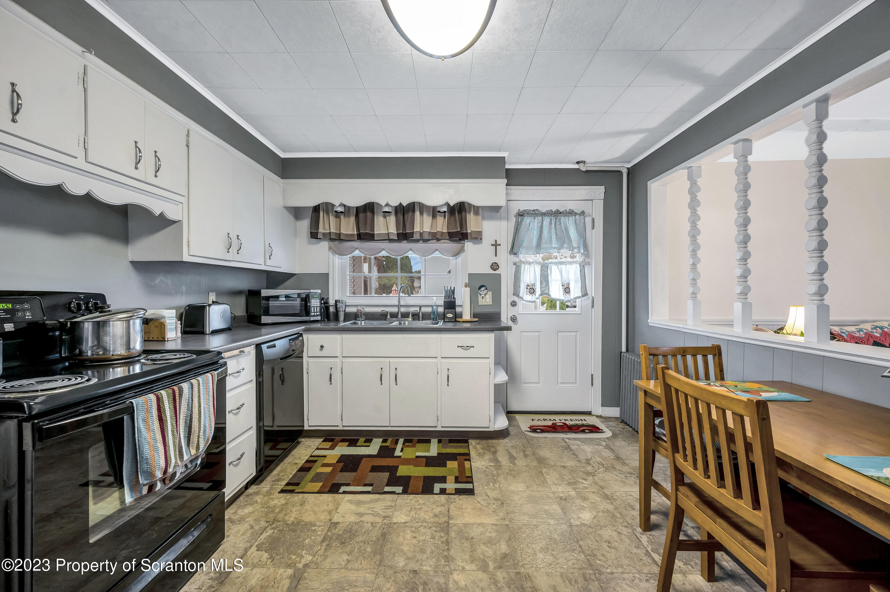 709 Meade Street Throop, PA 18512 - Photo 9 of 37 a kitchen with stainless steel appliances granite countertop a stove a sink and a refrigerator