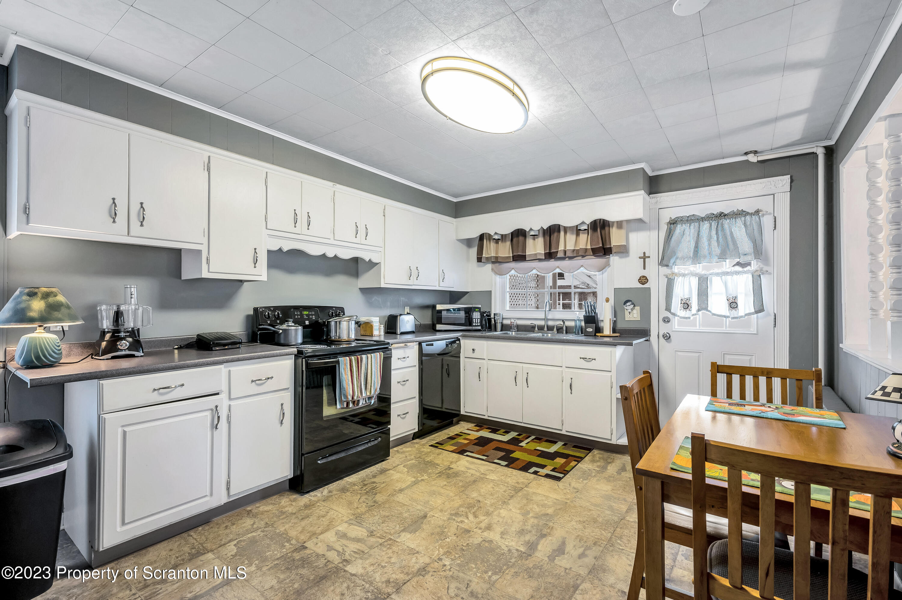 709 Meade Street Throop, PA 18512 - Photo 10 of 37 a kitchen with granite countertop a sink cabinets and stainless steel appliances