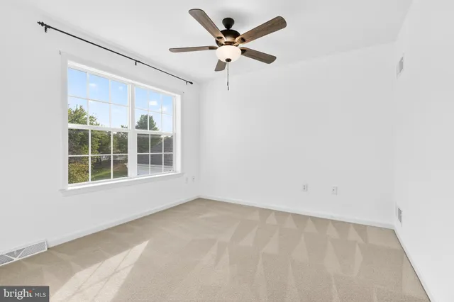 a spacious bathroom with a granite countertop sink a mirror and a shower