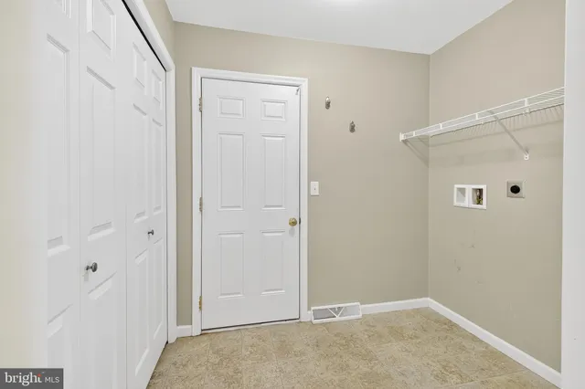 a bathroom with a granite countertop toilet a sink and a mirror