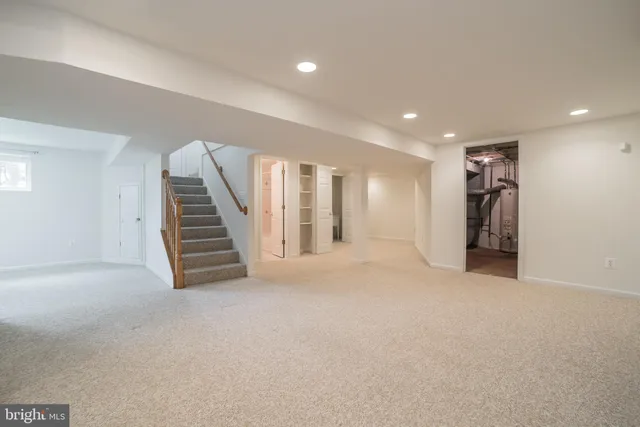 a view of an empty room with closet and stairs