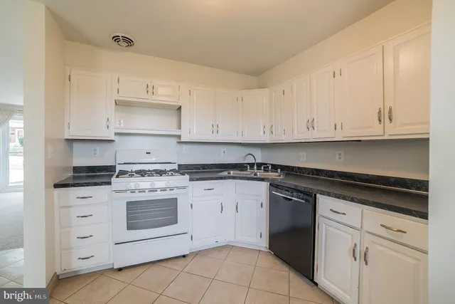 a kitchen with cabinets appliances and a sink