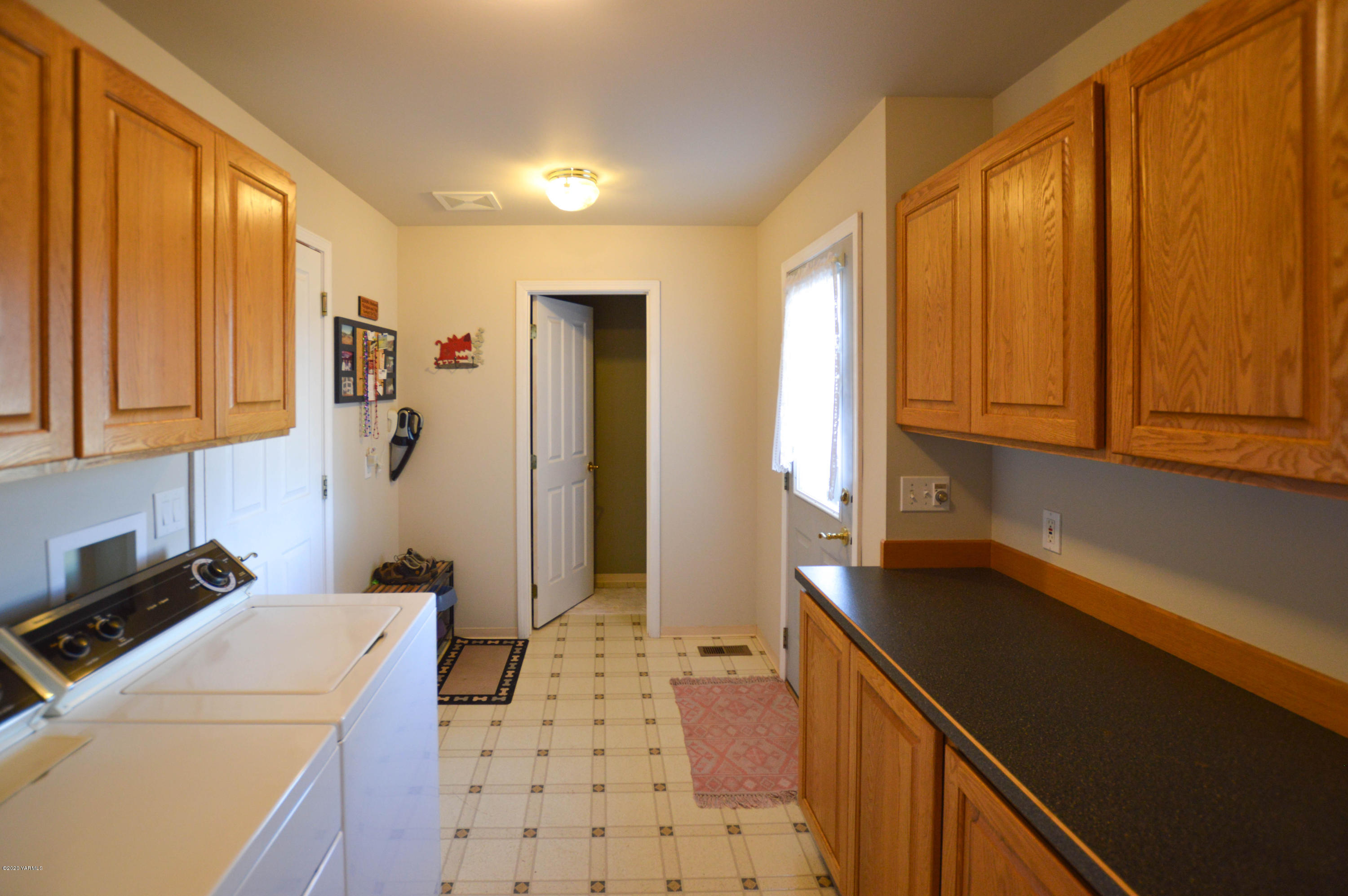 15871 Fisk Road Yakima, WA 98908 - Photo 14 of 16 a kitchen with a sink a refrigerator and cabinets