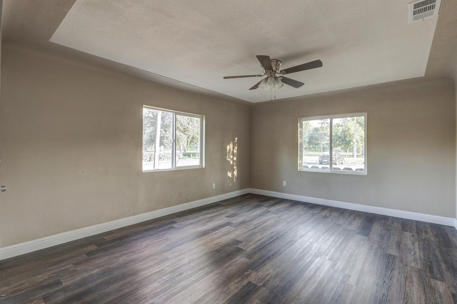 2520 P Street Merced, CA 95340 - Photo 8 of 23 a view of an empty room with wooden floor and a window