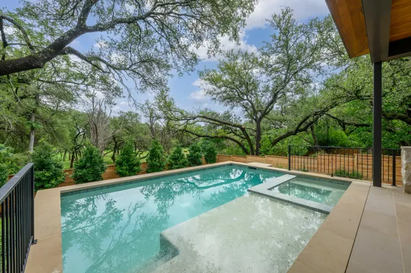 a view of a backyard with swimming pool