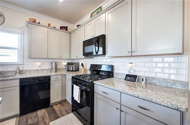 a living room with furniture a fireplace and a window