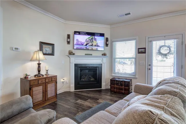 a spacious bedroom with a bed a couch and a chandelier