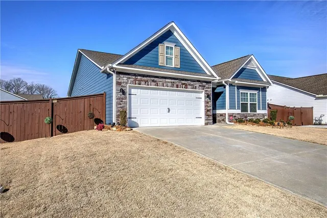 a bedroom with a bed and painting on the wall