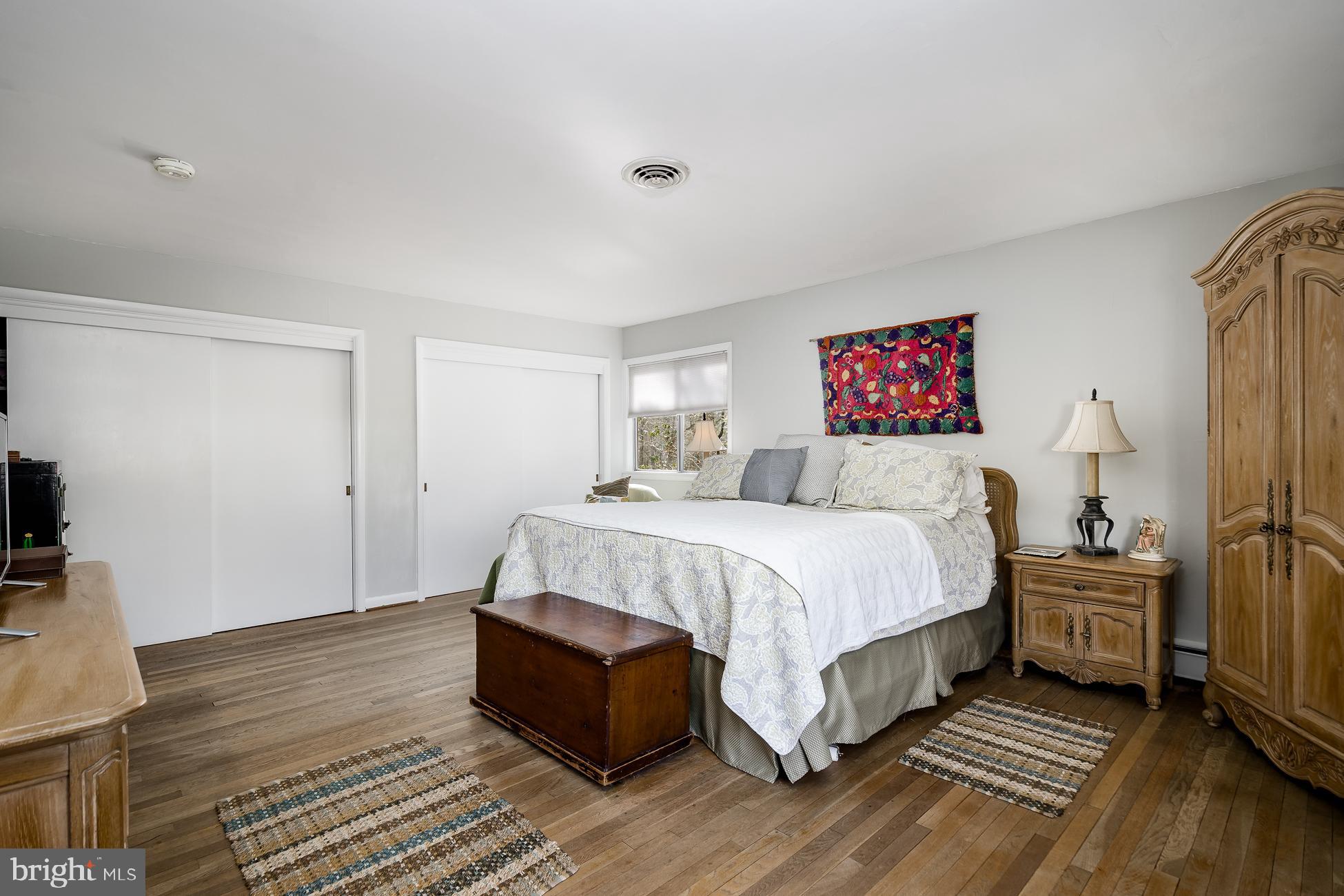 52 Winant Road Princeton, NJ 08540 - Photo 17 of 32 a bedroom with a bed and wooden floor