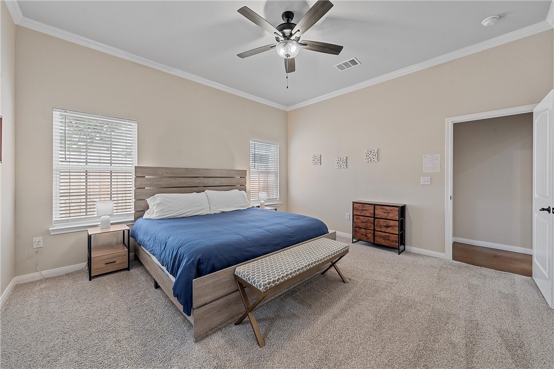 1121 Brook Avenue Waco, TX 76708 - Photo 13 of 19 a bedroom with a bed and a ceiling fan