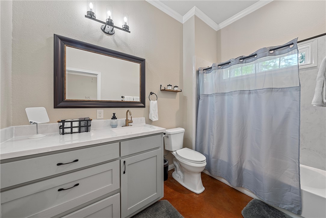1121 Brook Avenue Waco, TX 76708 - Photo 14 of 19 a bathroom with a sink a toilet a mirror and shower