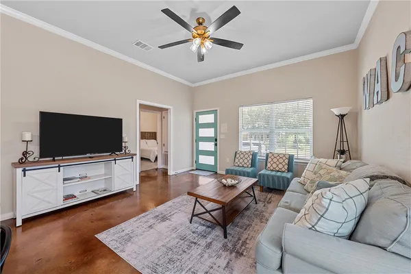 a living room with furniture and a flat screen tv