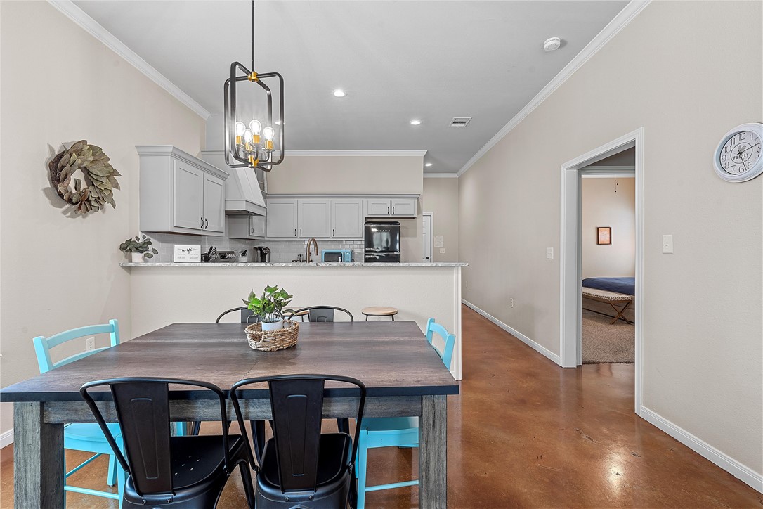 1121 Brook Avenue Waco, TX 76708 - Photo 6 of 19 a view of a dining room with furniture wooden floor and chandelier