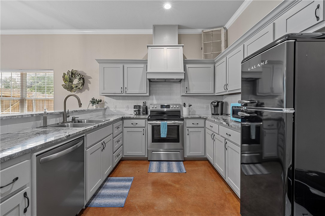 1121 Brook Avenue Waco, TX 76708 - Photo 7 of 19 a kitchen with granite countertop a sink stainless steel appliances and cabinets