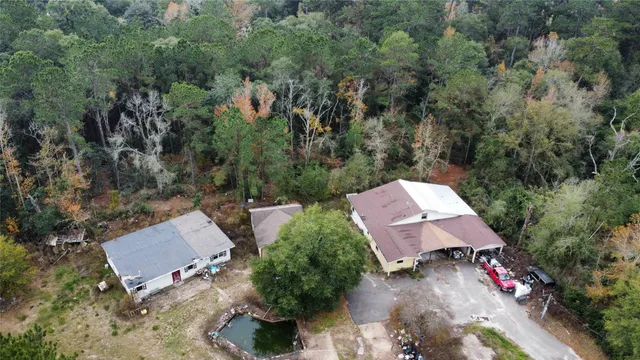 an aerial view of a house with yard