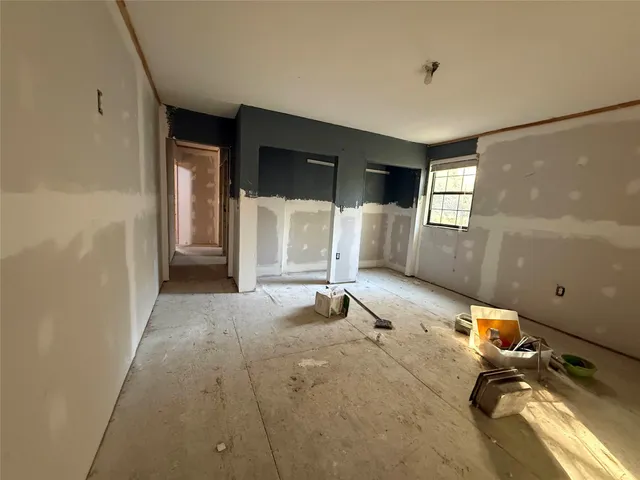 a room with gym equipment and a large window