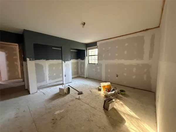 a room with gym equipment and a view of living room