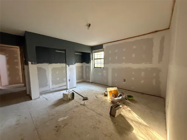 a room with gym equipment and a view of living room