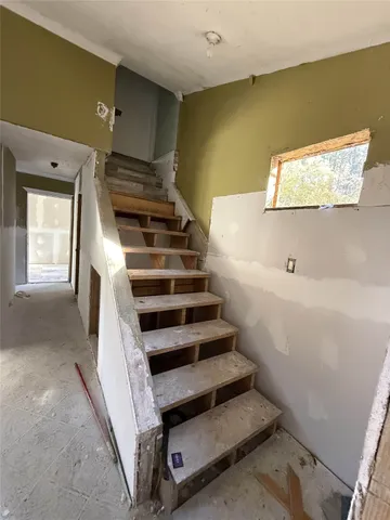 a view of a living room with furniture and a window