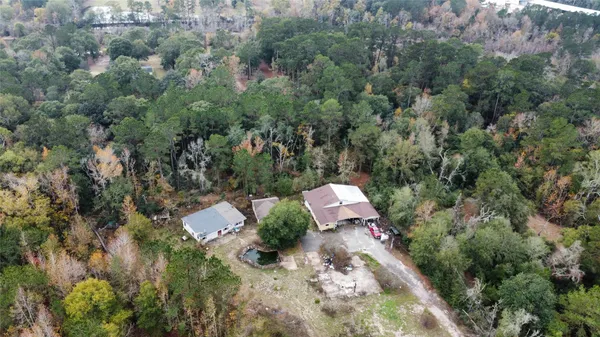 an aerial view of a house with a yard