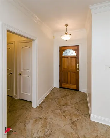 an empty room with windows fireplace and cabinet