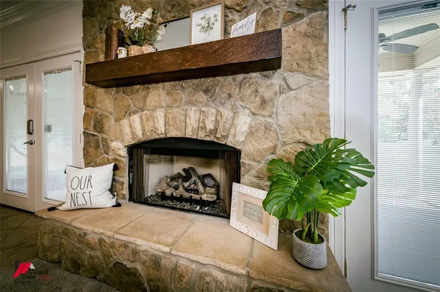 a bed with a fireplace and a potted plant