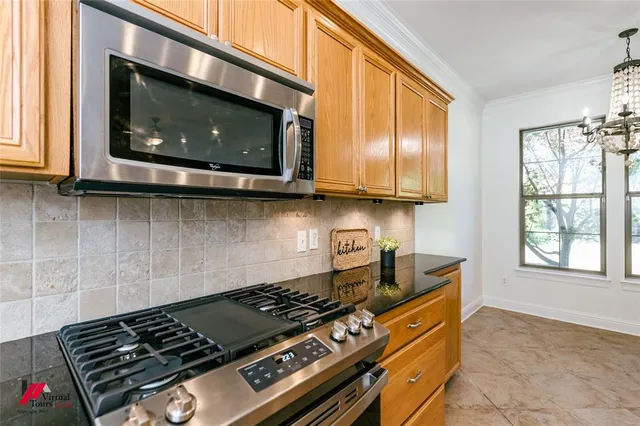 a kitchen with stainless steel appliances granite countertop a sink stove and cabinets