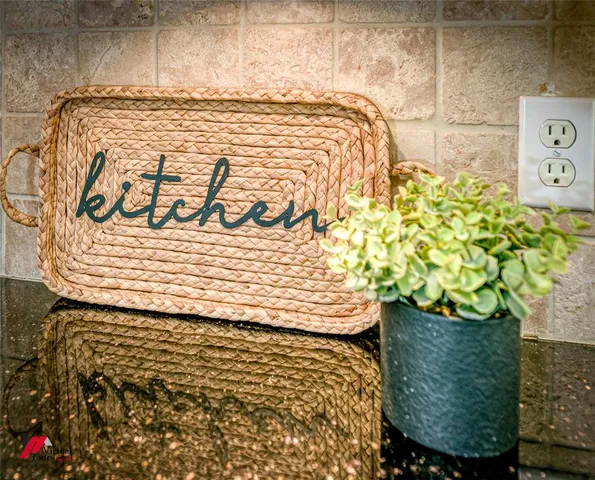 a kitchen with granite countertop cabinets stainless steel appliances a sink and a window