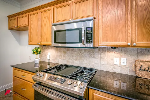 a kitchen that has a cabinets window and stainless steel appliances