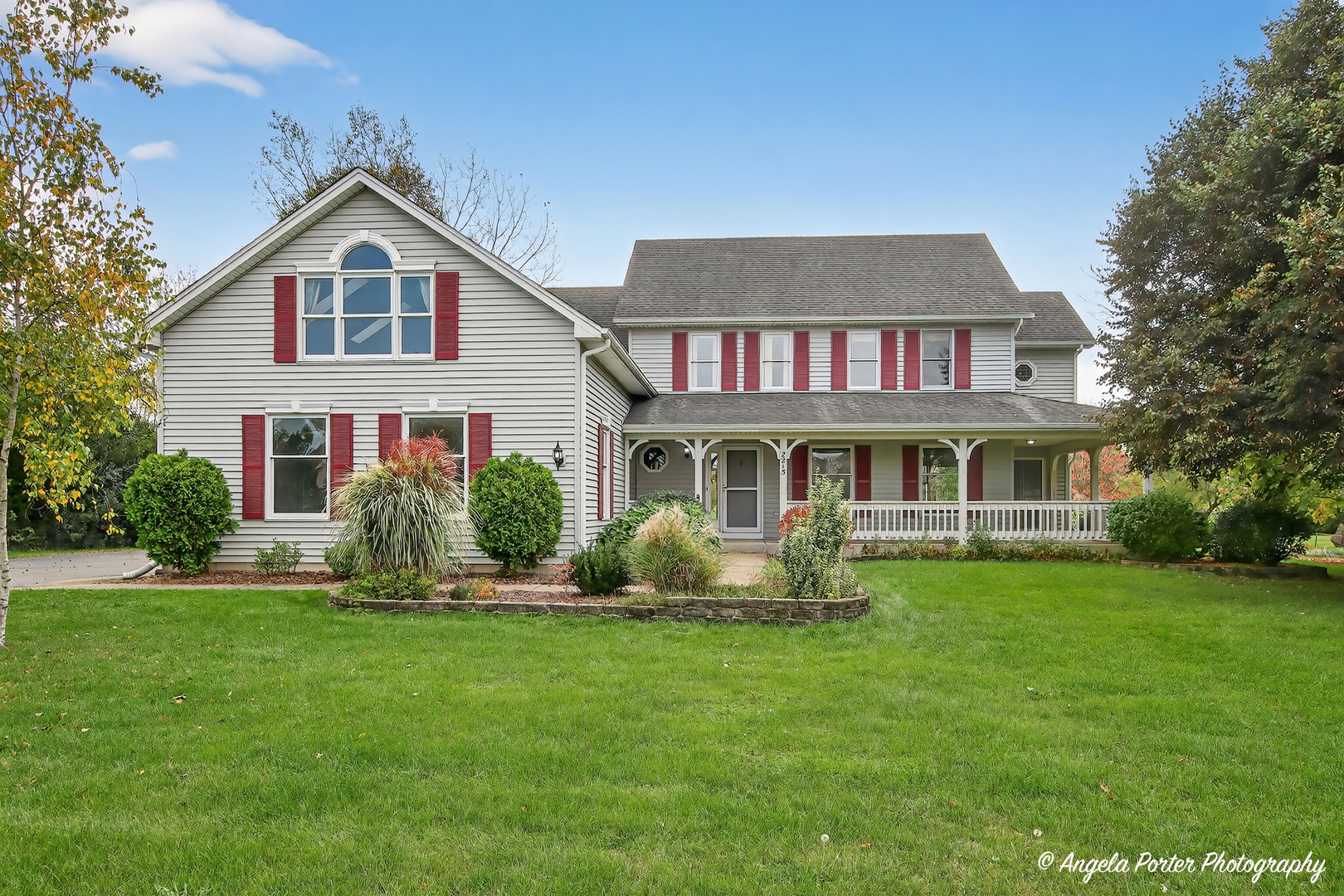 a front view of a house with a yard table and chairs