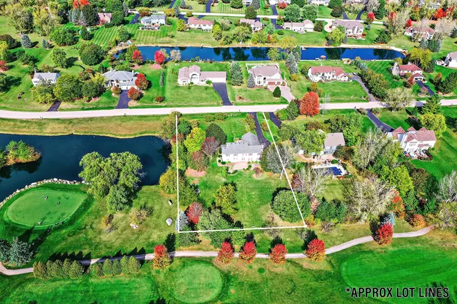 an aerial view of a residential houses with outdoor space