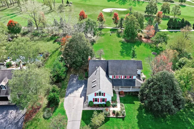an aerial view of a house with swimming pool outdoor seating and yard