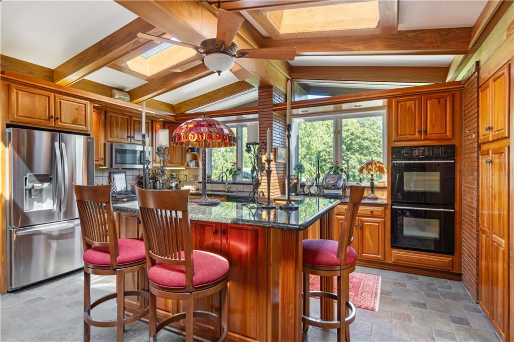 1789 Hastings Mill Road Pittsburgh, PA 15241 - Photo 12 of 46 a kitchen with stainless steel appliances kitchen island granite countertop furniture and a refrigerator