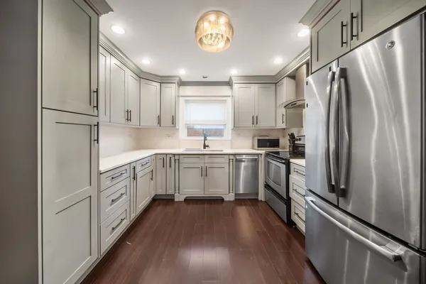 a kitchen with a refrigerator sink and cabinets