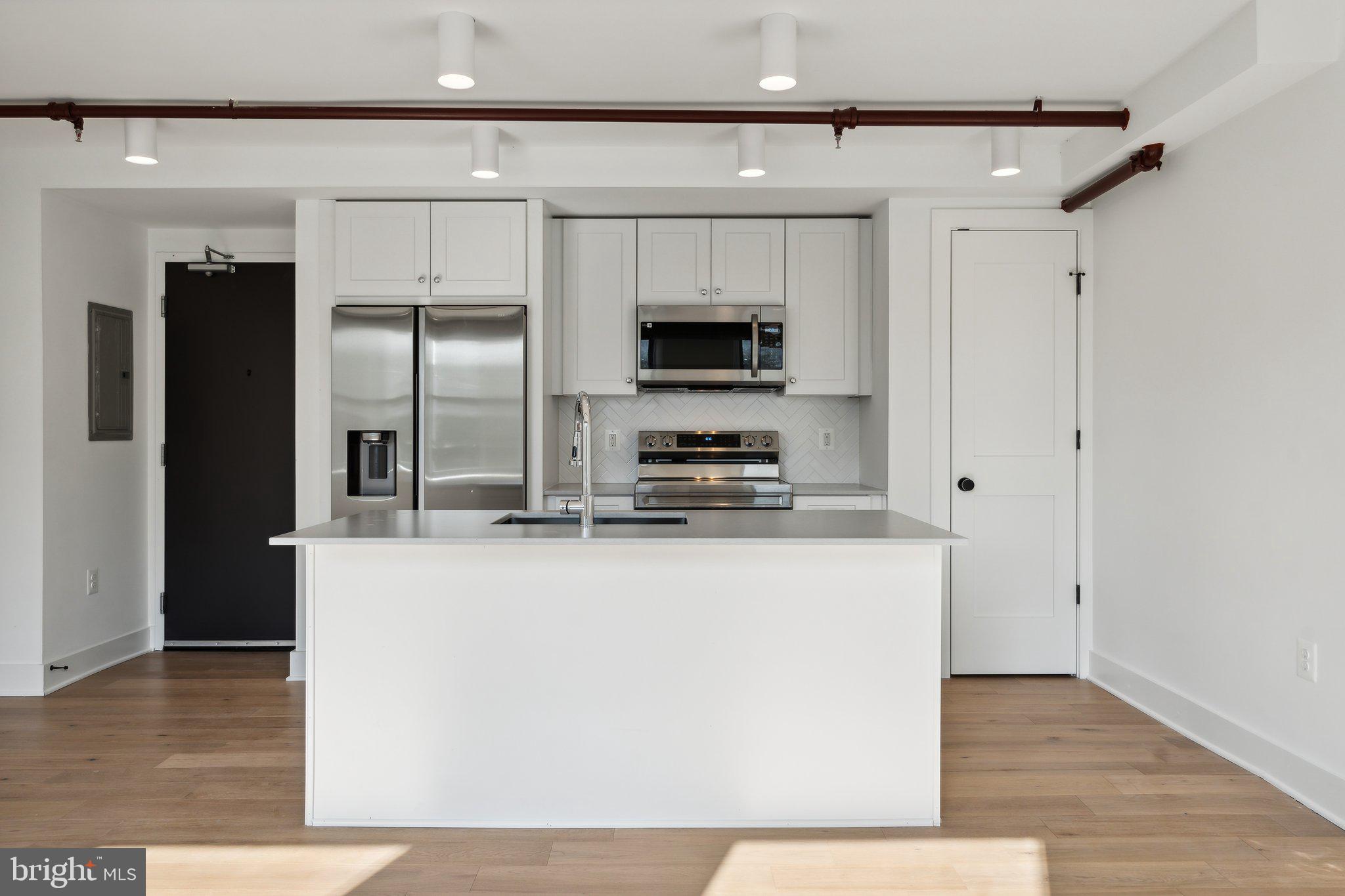 901 King Street, Unit 203 Alexandria, VA 22314 - Photo 1 of 52 a kitchen with stainless steel appliances a refrigerator and a stove top oven