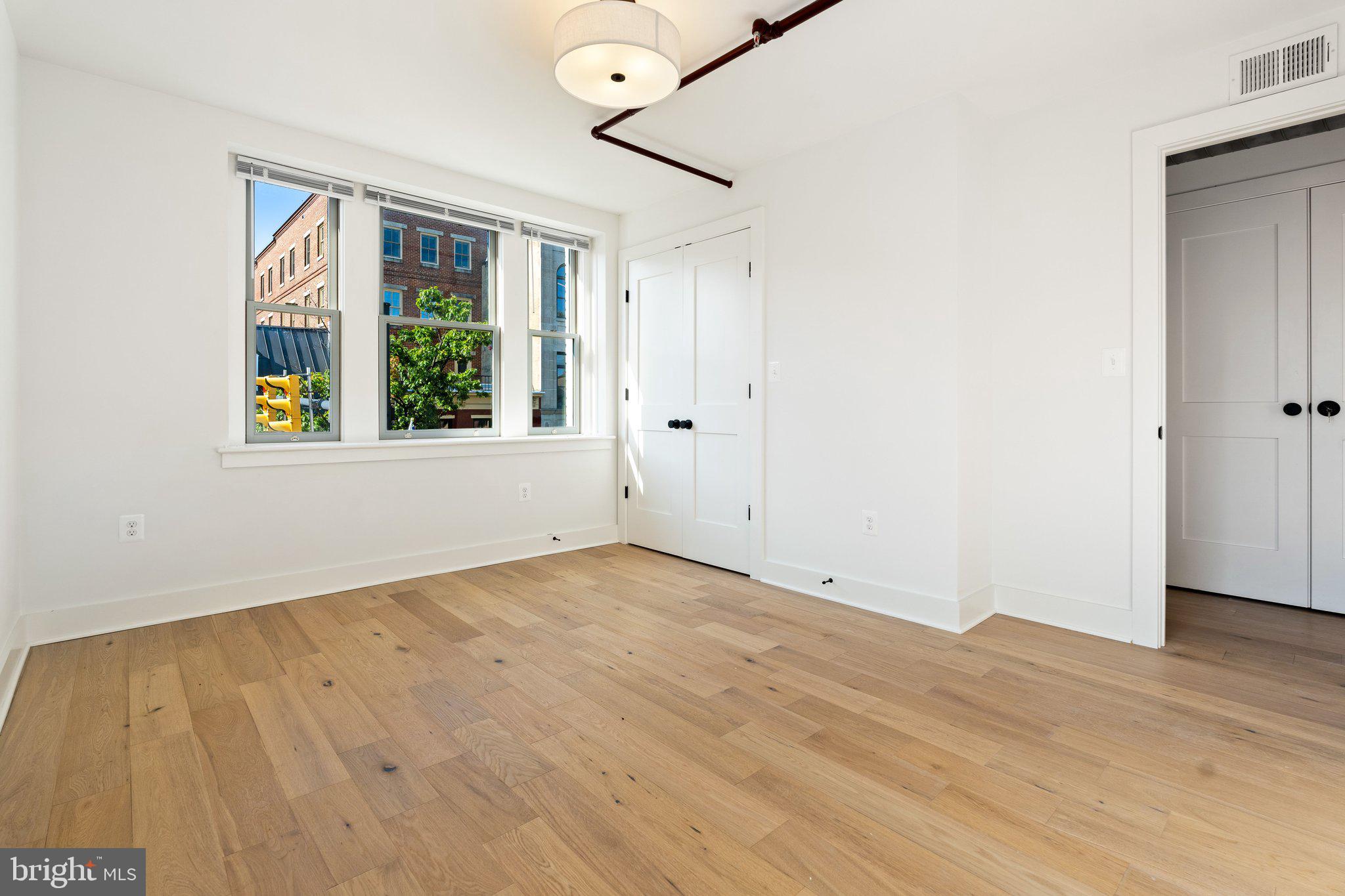 901 King Street, Unit 203 Alexandria, VA 22314 - Photo 11 of 52 wooden floor in an empty room