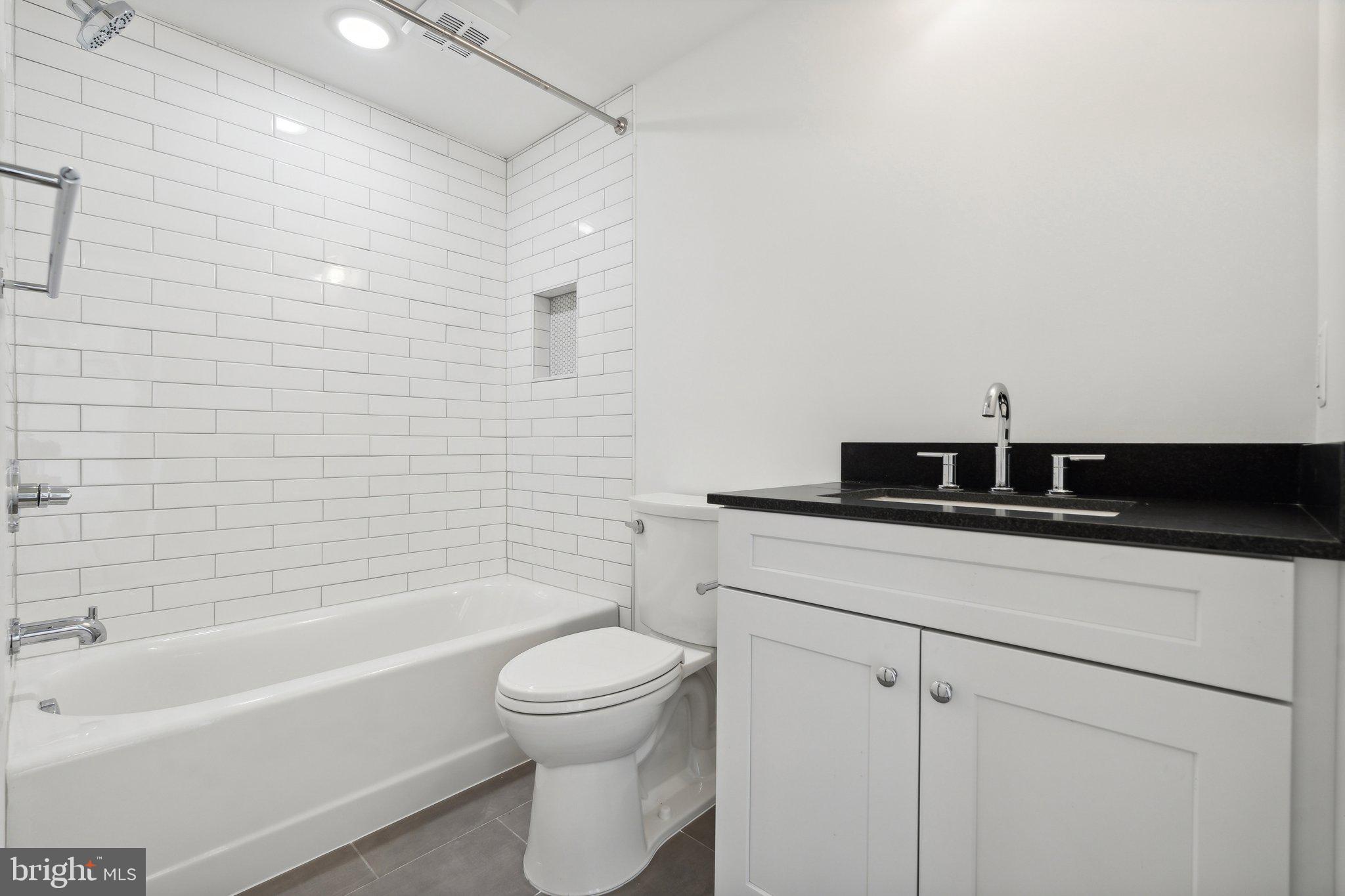 901 King Street, Unit 203 Alexandria, VA 22314 - Photo 14 of 52 a bathroom with a sink a toilet and a bathtub