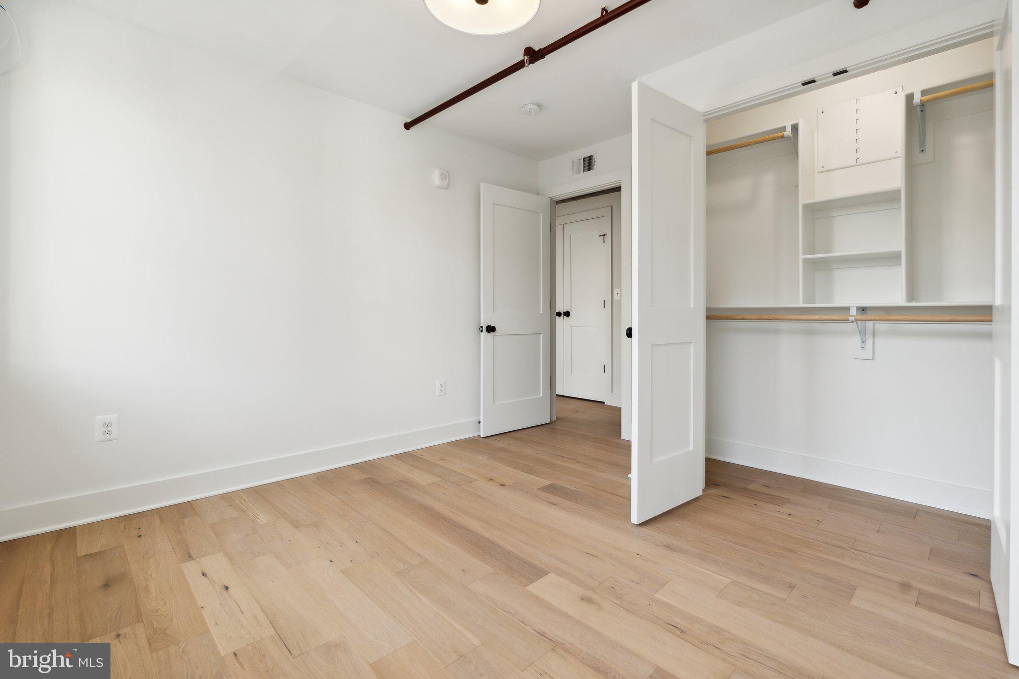 901 King Street, Unit 203 Alexandria, VA 22314 - Photo 2 of 52 a view of an empty room with wooden floor