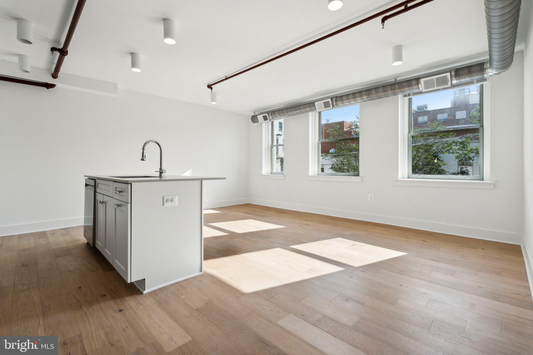 901 King Street, Unit 203 Alexandria, VA 22314 - Photo 21 of 52 a view of empty room with wooden floor and fan