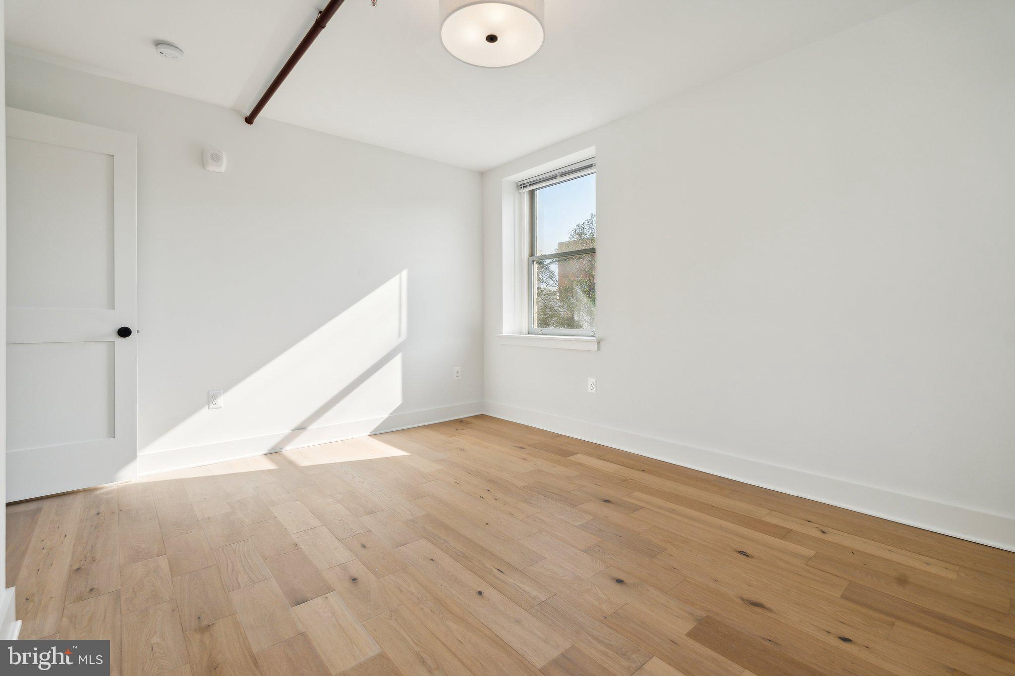 901 King Street, Unit 203 Alexandria, VA 22314 - Photo 10 of 52 a view of empty room with wooden floor and fan
