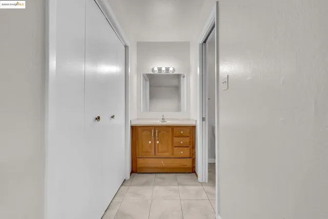 a view of bathroom with mirror