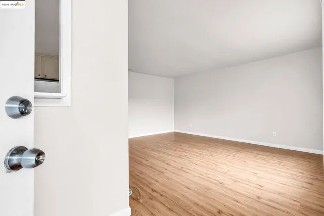 a view of a room with wooden floor
