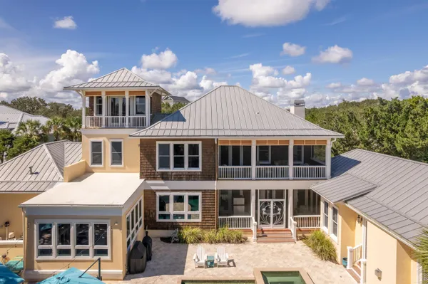 a view of a house with swimming pool and sitting area