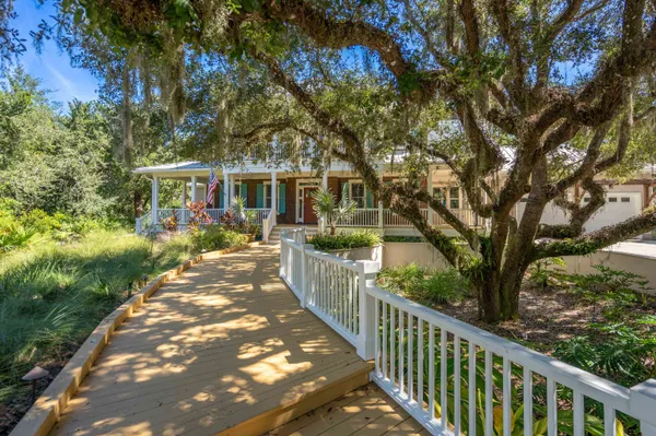 a view of a house with swimming pool and sitting area