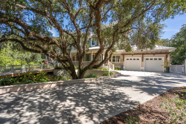 a front view of a house with swimming pool having outdoor seating