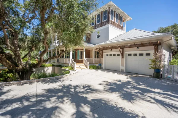 a front view of a house with swimming pool having outdoor seating